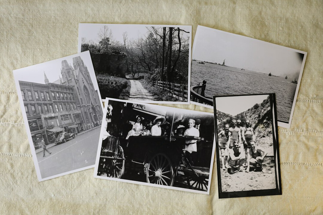 Vintage newspapers and photo prints scattered on a desk