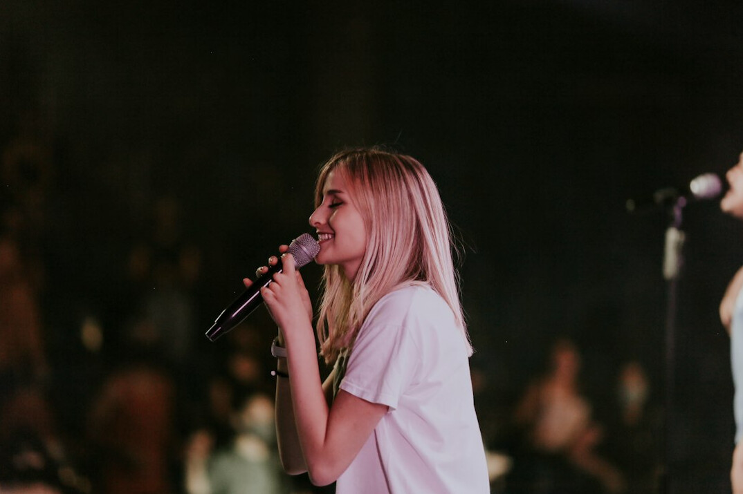 woman singing on stage